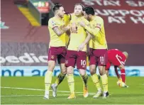  ?? PHOTO: GETTY IMAGES ?? Man of the hour . . . Burnley striker Ashley Barnes (centre) celebrates with teammates Josh Brownhill (left) and Dwight McNeil after scoring his side’s goal during its 10 win over Liverpool in their English Premier League clash in Liverpool yesterday.