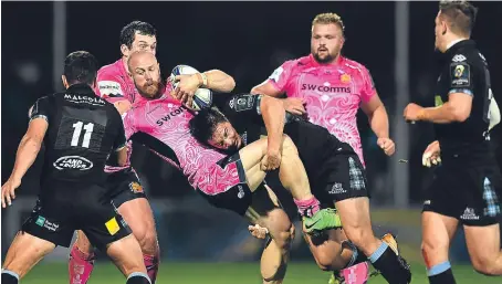  ?? Getty Images. ?? Glasgow’s Sam Johnson brings down James Short as the Scottish side press against Exeter Chiefs.