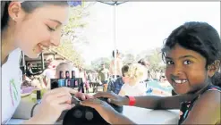  ??  ?? NAILED IT: Kayla Osmond, 16, paints 6-year-old Talia Prahaladh’s nails