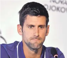  ?? AP PHOTO ?? DOWN AND OUT: Novak Djokovic ponders a question during yesterday’s press conference in Belgrade, Serbia, where he announced he’s missing the rest of the tennis season due to a right elbow injury.