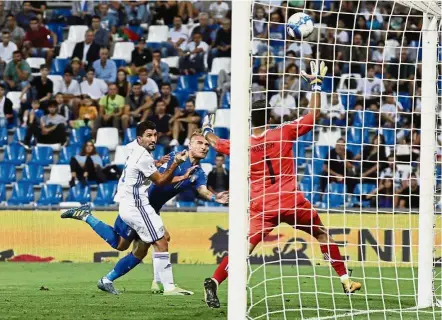  ?? — AP ?? Cool head: Italy’s Ciro Immobile (centre) scoring past Israel goalkeeper Ariel Harush during the World Cup Group G qualifying match at the Mapei Stadium in Reggio Emilia, Italy, on Tuesday.