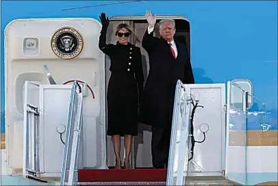  ?? LUIS M. ALVAREZ / AP ?? President Donald Trump and first lady Melania Trump wave to a crowd Wednesday as they board Air Force One at Andrews Air Force Base, Md.