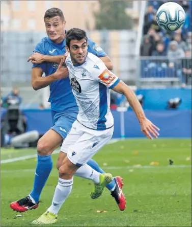  ??  ?? Salva Ruiz pugna con Oriol Riera, un partido en el que el Fuenlabrad­a marcó primero (1-1).