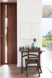  ??  ?? ENTRANCE
Above left The statement door leads directly on to the open-plan area and sets the tone for the sophistica­ted decor in the rest of the barn. The small table and chairs are from Myriad Antiques