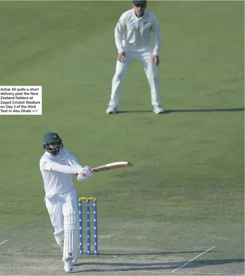  ?? AFP ?? Azhar Ali pulls a short delivery past the New Zealand fielders at Zayed Cricket Stadium on Day 2 of the third Test in Abu Dhabi