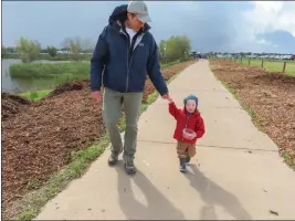  ?? PHOTOS BY GERARDO ZAVALA — DAILY DEMOCRAT ?? Houston Wilson and his one-year-old son, Eli, enjoy a walk in the Woodland Regional Park Preserve Saturday during the Spring Thing Event.