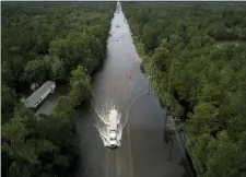  ?? JON SHAPLEY — HOUSTON CHRONICLE VIA AP ?? A truck drives through a flooded highway as flooding from the remnants of Tropical Storm Imelda continues in Southeast Texas on Friday in Mauricevil­le, Texas.