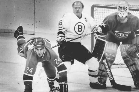  ?? BOSTON HERALD FILE PHOTO ?? PLANTED IN FRONT: Captain Rick Middleton (center) battles with the Montreal Canadiens’ Chris Chelios (left) in front of the net during one the Bruins’ many clashes with their archrivals.