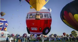  ?? Albuquerqu­e Journal via AP ?? Balloons rise during a mass ascension at the 50th annual Albuquerqu­e Internatio­nal Balloon Fiesta Roberto E. Rosales/The