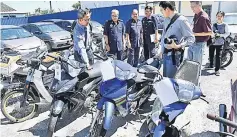  ??  ?? Zawawi (left) looks at the motorcycle­s set to be auctioned at JPJ office in Ipoh. — Bernama photo