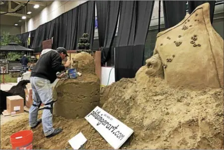  ?? PHOTOS BY LINDSAY MORAN — FOR THE RECORD ?? Local artist Phil Singer works on an elaborate sand sculpture that will be one of the centerpiec­es of the annual Capital District Garden & Flower Show this weekend in the McDonough Sports Complex at Hudson Valley Community College.