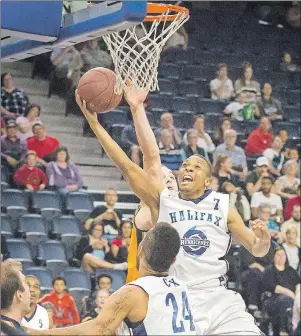  ?? THE CHRONICLE HERALD ?? Halifax Hurricanes guard Joey Haywood gets a shot off as Island Storm forward Al Richter defends Monday in Halifax during Game 5 of the National Basketball League of Canada semifinal.