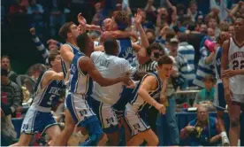  ??  ?? Christian Laettner is mobbed by his Duke teammates after hitting the game-winning basket against Connecticu­t to send the Blue Devils to the 1990 Final Four. Photograph: Bettmann/Bettmann Archive