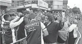  ?? ASSOCIATED PRESS ?? Amid tight security, Courteener­s’ fans are searched as they arrive for a concert at Old Trafford Cricket Ground in Manchester, England, on Saturday.