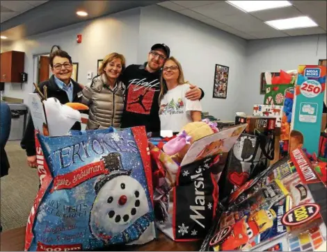  ?? SUBMITTED ?? Tony Harvey, Kathy Stewart Josh Ledenican and MaryAnn McClintock with the bags of gifts for his family are shown.
