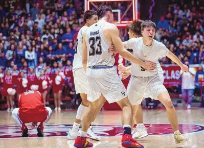  ?? CHANCEY BUSH/JOURNAL ?? Volcano Vista senior Anthony Gonzales (right) celebrates after the Hawks knocked off Sandia 43-31 at the Pit for their second straight 5A title. The win handed Hawks head coach Greg Brown his third state title with Volcano Vista and fourth overall.