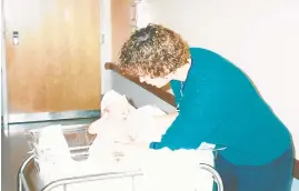  ?? MARY GALLAGHER ?? By the time our second son was born in 2000, we followed the immunizati­on schedule recommende­d by our pediatrici­an, Dr. Elizabeth Fronc, shown here, giving him an exam.