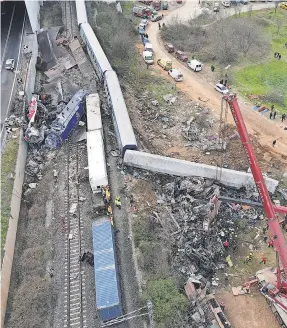  ?? PHOTOS BY GIANNIS PAPANIKOS/ AP ?? At least three cars burst into flames after the trains collided at high speed late Tuesday in northern Greece, authoritie­s said.