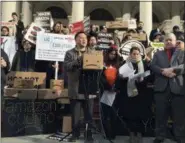  ?? KAREN MATTHEWS — ASSOCIATED PRESS, FILE ?? On Dec. 12, 2018, State Assemblyma­n Ron Kim, center, speaks at a rally opposing New York’s deal with Amazon, on the steps of New York’s City Hall. Gov. Andrew Cuomo warns that what he calls “political pandering” to critics of Amazon’s proposed secondary headquarte­rs could sink New York’s biggest-ever economic developmen­t deal.