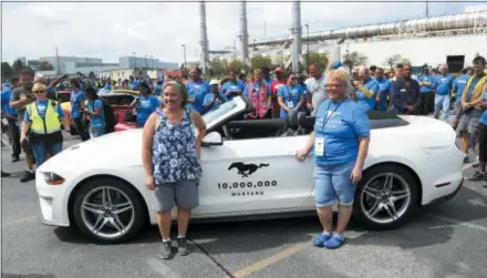  ?? CARLOS OSORIO — THE ASSOCIATED PRESS ?? Employees Rose Boylan, left, and Michelle Cotter stand next to the 2019 GT Mustang, the 10 millionth Mustang built by Ford outside the Flat Rock Assembly plant Wednesday in Flat Rock, Mich.