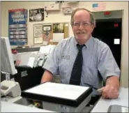  ?? Gazette staff photo by BOB RAINES ?? Mark Walsh stands behind the counter at the Dresher post office, where he has worked for 21 years.