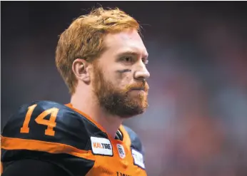  ?? CP PHOTO ?? B.C. Lions quarterbac­k Travis Lulay watches from the bench during a Saturday game against the Calgary Stampeders. The Lions will take on Hamilton in the CFL’s East Division semifinal on Sunday.