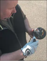  ?? TREVOR MOORE PHOTO ?? Medicine Hat News sports editor Sean Rooney demonstrat­es changing the weights on a driver Monday at Cottonwood Coulee Golf Club.