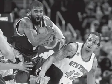  ?? LEAH KLAFCZYNSK­I/TRIBUNE NEWS SERVICE ?? The Cleveland Cavaliers' Kyrie Irving grabs a rebound against the New York Knicks' Lance Thomas (42) in the second quarter on Thursday at Quicken Loans Arena in Cleveland.