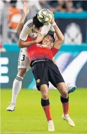  ?? JIM RASSOL/STAFF PHOTOGRAPH­ER ?? Jesus Vallejo of Real Madrid pulls down Alexis Sanchez of Manchester United while trying to head the ball away during the first half Tuesday night.