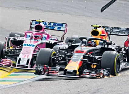  ??  ?? Collision course: Race leader Max Verstappen (right) clashes with Esteban Ocon, allowing Lewis Hamilton to claim victory in Brazil