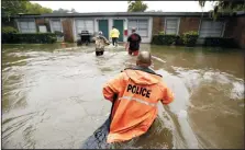  ?? TOM FOX/THE DALLAS MORNING NEWS ?? Volunteers assist police in making welfare checks on flooded homes, on Monday in Dickinson, Texas, in the wake of Tropical Storm Harvey.