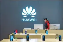  ??  ?? A staff member is seen inside a Huawei retail store in Shanghai recently.