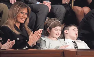  ??  ?? First lady Melania Trump with Grace Eline and Joshua Trump, special guests of President Donald Trump, attend the State of the Union address in the chamber of the U.S. House of Representa­tives on Feb. 5 in Washington. ALEX WONG / GETTY IMAGES