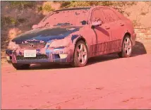  ?? Dan Watson/The Signal ?? A car is stained pink in July from a drop of fire retardant on Ruthspring Drive in Sand Canyon.