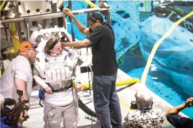  ?? Brett Coomer/Houston Chronicle via AP ?? ■ Astronaut candidate Zena Cardman gets suited up for training in NASA’s neutral buoyancy laboratory on April 12 in Houston.