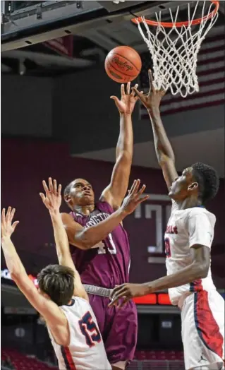  ?? BOB RAINES — DIGITAL FIRST MEDIA ?? Abington’s Eric Dixon, center, takes a shot against Plymouth Whitemarsh’s Matt Walker, left, and Naheem McLeod.