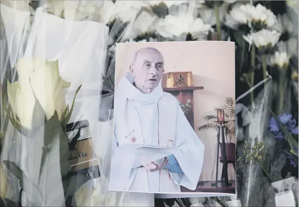  ?? PICTURE: AP. ?? GLOBAL TERROR: Floral tributes for 84-year-old priest Fr Jacques Hamel who was brutally murdered by Islamist terrorists while he conducted morning Mass in France.