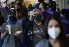  ?? Hyoung Chang, Denver Post file ?? Rockies fans wear masks during opening day at Coors Field on April 1.