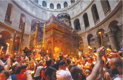  ?? (Olivier Fitoussi/Flash90) ?? ORTHODOX CHRISTIAN worshipper­s take part in the Holy Fire ceremony at the Church of the Holy Sepulchre in Jerusalem’s Old City last month.