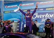  ?? AP PHOTO BY CHARLES KRUPA ?? Driver Denny Hamlin celebrates after winning the NASCAR Cup Series 301 auto race at New Hampshire Motor Speedway in Loudon, N.H., Sunday.