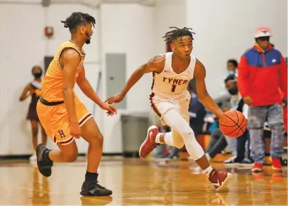  ?? STAFF PHOTO BY TROY STOLT ?? Tyner’s Trent Gresham dribbles downcourt during Thursday night’s game against visiting Howard for the Region 3-AA championsh­ip. The Rams won 53-49, with Greshman helping lead the way as he has all season for Tyner, which improved to 20-2.