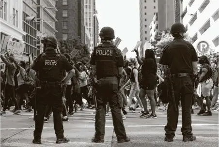  ?? Godofredo A. Vásquez / Staff photograph­er ?? People join George Floyd’s family at a march in downtown Houston in June. A 45-person task force, appointed after police officers in Minnesota killed Floyd, will suggest new policies that would require Houston police to publicize complaints against officers.