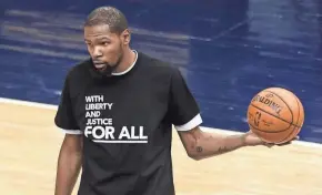  ?? GETTY IMAGES ?? Kevin Durant wears a shirt supporting social justice before the Nets-Timberwolv­es game Tuesday. The game was the first in Minneapoli­s since 20-year-old Daunte Wright was killed by a police officer.