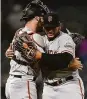  ?? Dustin Bradford / Getty Images ?? Kervin Castro (right) and Curt Casali celebrate Tuesday.