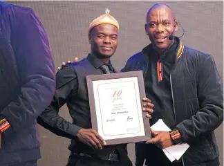  ?? ?? Abby Maunatlala receives his 10-year service award from Sammy Mokhele (general manager). Left: Kwena Zandiwe receives her 15 year service award from Sammy Mokhele (Meropa Casino general manager).