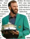  ?? Foto: dpa ?? Dustin Johnson und seine Trophäe.