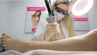  ??  ?? Nurse practition­er Maria Nunes performs laser hair removal at Body Details in Boca Raton.