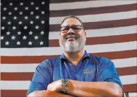  ?? Bizuayehu Tesfaye ?? Las Vegas Review-journal @bizutesfay­e Tom Pedro, director of maintenanc­e at Terrible Herbst Co., in front of a giant American flag at his work Monday in Las Vegas.