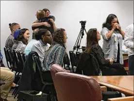  ?? MARK GOKAVI / STAFF ?? Supporters of Tyra Patterson embrace after the Ohio Parole Board voted Tuesday to release her from prison in December. Patterson, who is incarcerat­ed at the Northeast Pre-Release Center, was not present for the hearing in Columbus.