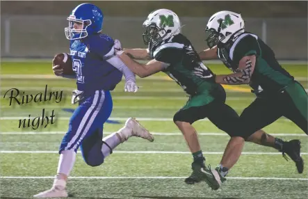  ?? NEWS PHOTO RYAN MCCRACKEN ?? Crescent Heights Vikings quarterbac­k Kobe Willis is driven out of bounds by Hat High’s Aaron Kruger (middle) and Aayden Callan during a high school football game on Friday night at the Methanex Bowl. Hat High rallied from a 14-8 halftime deficit to win the game 23-20, bouncing back from a 21-8 loss to the Vikings last weekend.